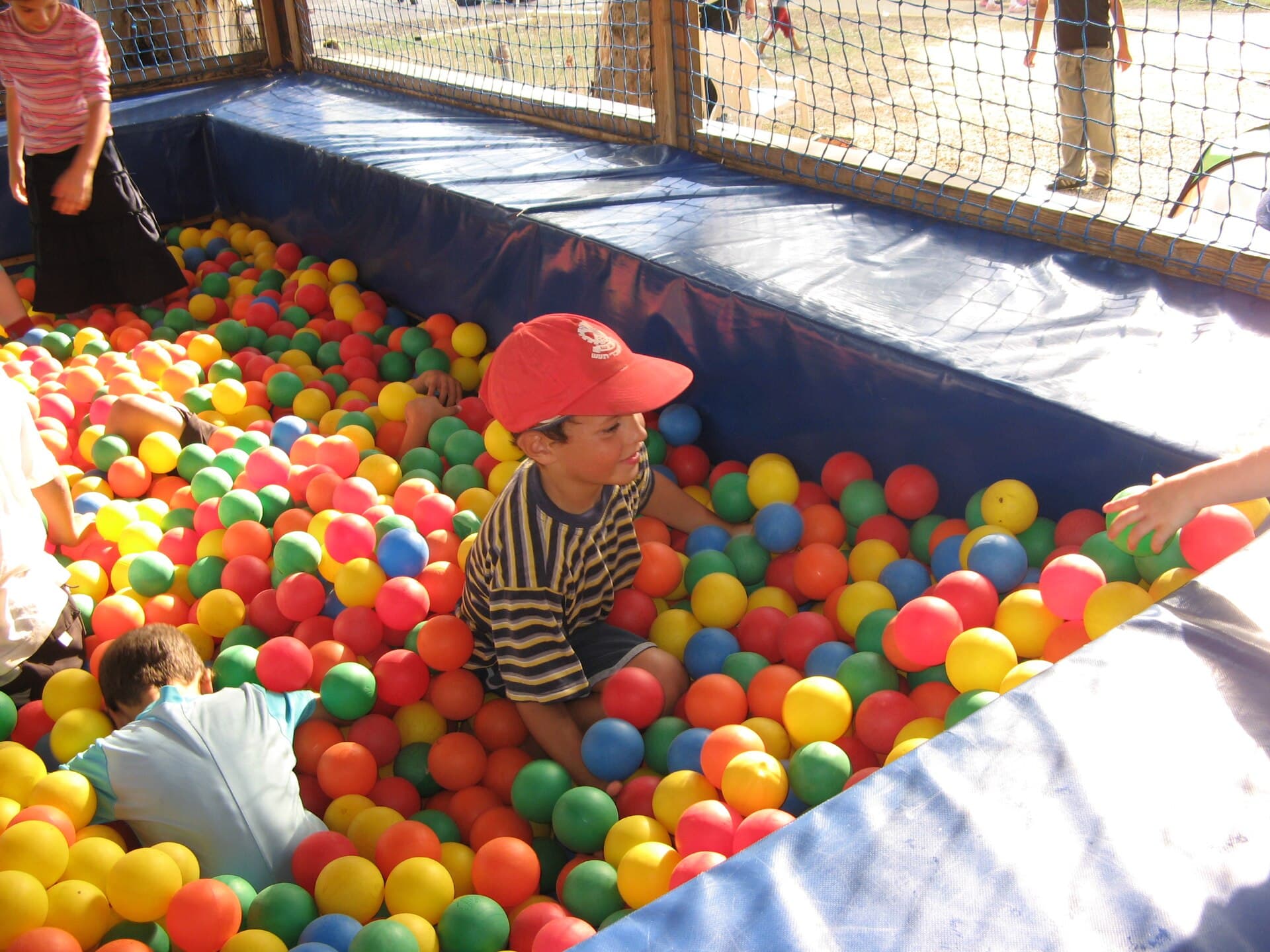 A colourful ball pit full of soft balls in a toddler play space.